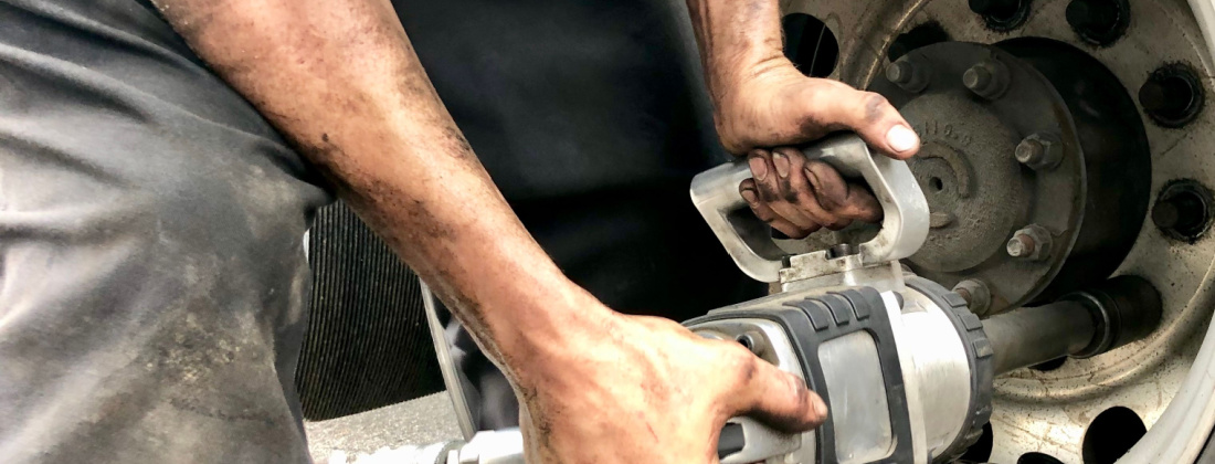 Man removing a bolt during mobile tire service